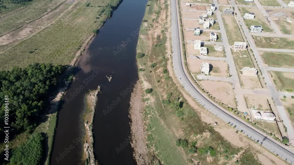 An impressive aerial view captures a harmonious blend of an urban landscape, a scenic coastal road, a flowing river, dense jungle, and fertile agricultural fields. An impressive aerial view captures a harmonious blend of an urban landscape, a scenic coastal road, a flowing river, dense jungle, and fertile agricultural fields.
