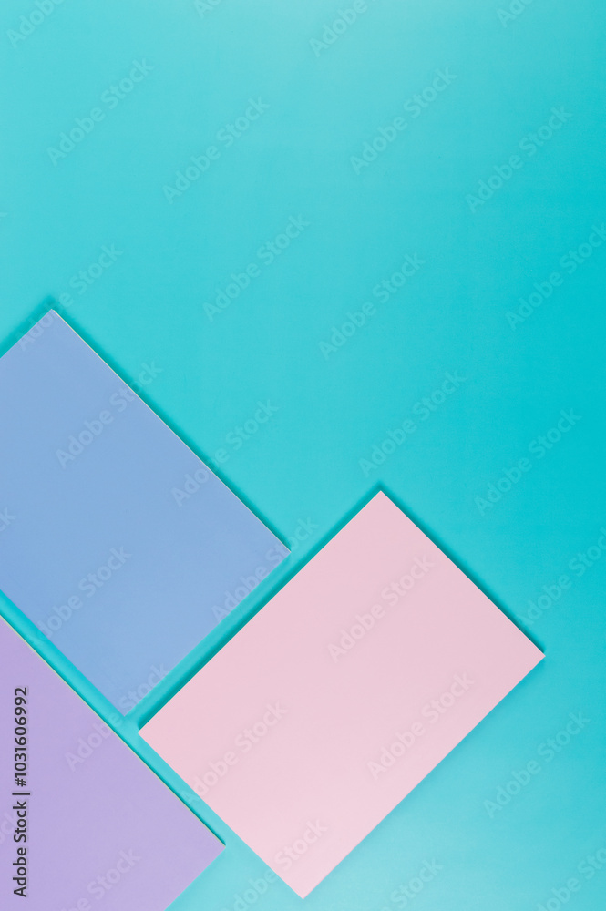 Top view of pink, purple and blue notebooks on blue background. Pink, yellow and blue pens, school, office wallpaper. Flat lay, copy space. Top view of pink, purple and blue notebooks on blue background. Pink, yellow and blue pens, school, office wallpaper. Flat lay, copy space.