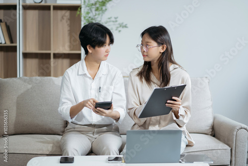 women doing finances and calculate on desk about cost at home office.