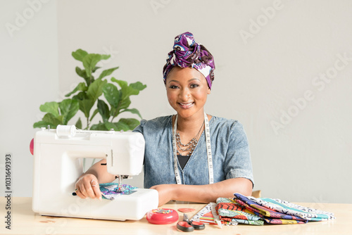 Beautiful Nigerian woman smiling while sowing photo