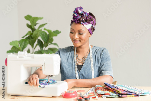 Woman using a sowing machine to make headwraps photo