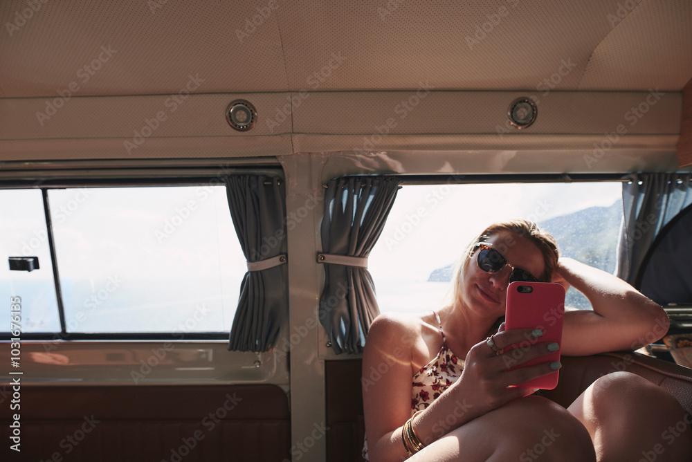Naklejka premium Woman, travel and smartphone in van with road trip for social media scroll, online texting and journey to location. Adventure, person and phone in transport for text message or mobile chat in vehicle