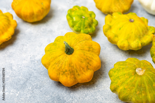 Pattypan zucchini on a textured kitchen table. squash. Fresh organic pattypan squashes on background. Vegan. Farmer's Market. Patisson. Space for text. Copy space. photo