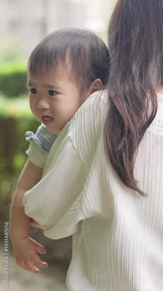 A Taiwanese family, consisting of a father in his 30s, a mother in her 20s, and their 1-year-old daughter, are walking apartment in Taichung City, Taiwan.Realtime, Vertical Video. A Taiwanese family, consisting of a father in his 30s, a mother in her 20s, and their 1-year-old daughter, are walking apartment in Taichung City, Taiwan.Realtime, Vertical Video.