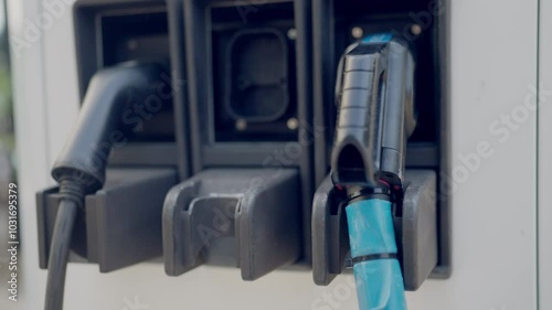 Wallpaper Mural A blue and black hose is plugged into a gas station. The hose is attached to a gas pump Torontodigital.ca