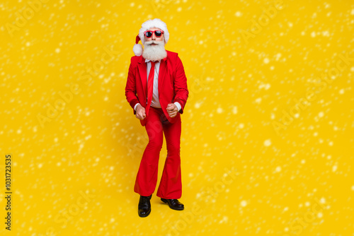 Full length photo of handsome excited claus wear red tux costume having fun disco dancing empty space isolated yellow color background photo