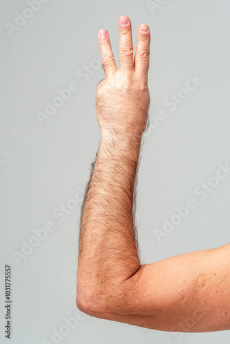 Foto Hand gesture indicating the number three against a plain background