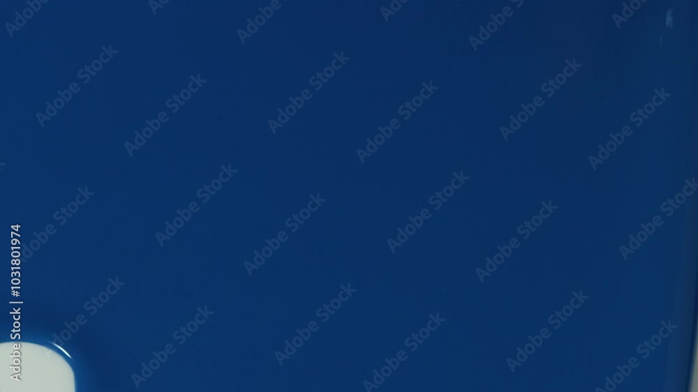 close up on blue liquid that falls from top to bottom on a white background, can be used to advertise products with blue elements
close up on blue liquid that falls from top to bottom on a white background, can be used to advertise products with blue elements