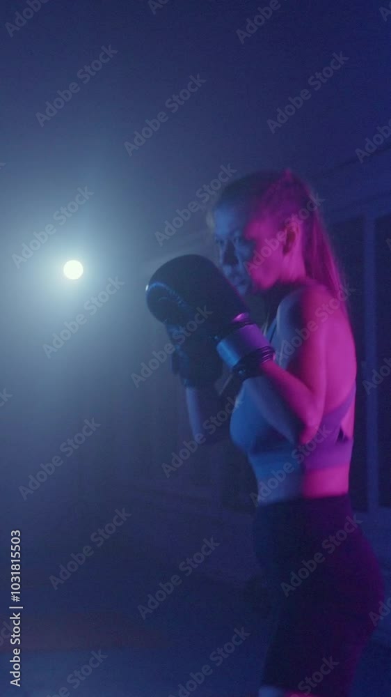 Intense boxing training session at a neon-lit gym with a dedicated female athlete and her coach Intense boxing training session at a neon-lit gym with a dedicated female athlete and her coach