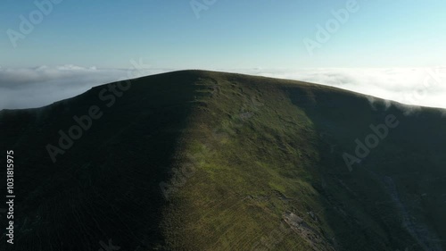 Aerial drone view of a beautiful mountain range with clouds and a sunny day in the Pyrenees, France