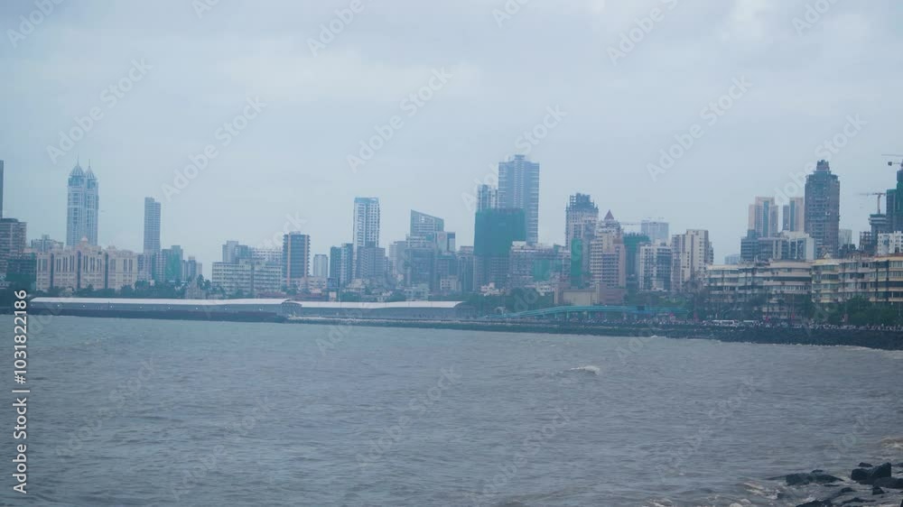 Pan shot of skyline buildings and skyscrapers of Mumbai with ocean in front on a cloudy monsoon day Pan shot of skyline buildings and skyscrapers of Mumbai with ocean in front on a cloudy monsoon day