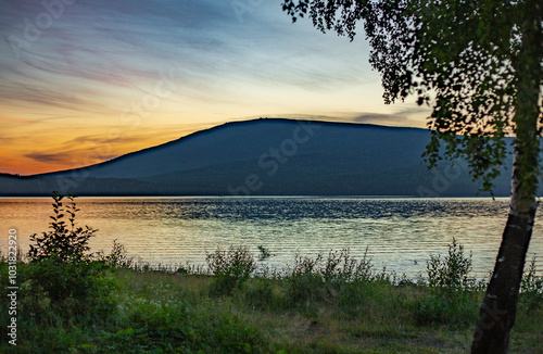 Sunset in the city of Kachkanar on the embankment of the reservoir. July 2024. photo