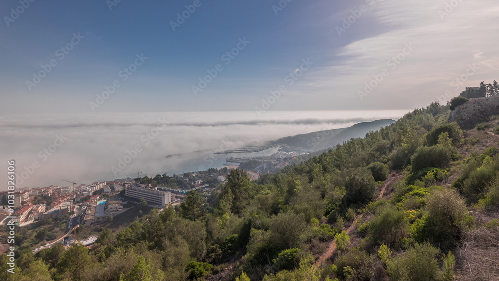 Panorama showing aerial View of Sesimbra Town and Port covered by fog timelapse, Portugal. Panorama showing aerial View of Sesimbra Town and Port covered by fog timelapse, Portugal.
