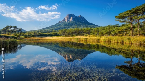 A clear, tranquil lake in Jeju Island reflecting the towering Hallasan volcano.