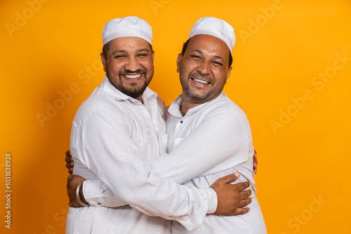 Happy Indian Muslim Men Hug each other celebrating Eid photo