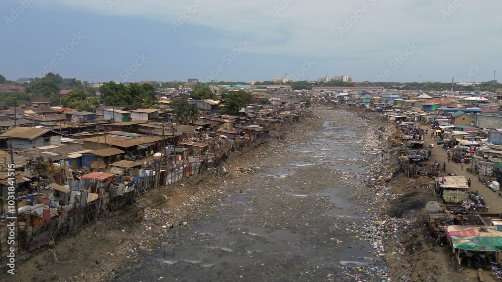People live in slums immersed immersed in toxic waste that poisons the land and river waters in Africa Africa Ghana AGBOGBLOSHIE. high environmental pollution area , Climate change global warming