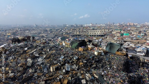 Obraz na płótnie Ghana, Accra, AGBOGBLOSHIE drone view Odaw River the largest landfill illegal dump in Africa for electronic and plastic waste from the Western world. mountain of toxic waste, environmental disaster w salonie