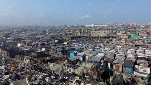 Obraz na płótnie Ghana, Accra, AGBOGBLOSHIE drone view Odaw River the largest landfill illegal dump in Africa for electronic and plastic waste from the Western world. mountain of toxic waste, environmental disaster w salonie