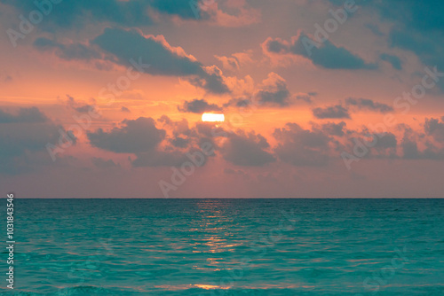 Sunrise at Playa de Muro Beach, Alcudia, Mallorca, with an orange sky and turquoise sea