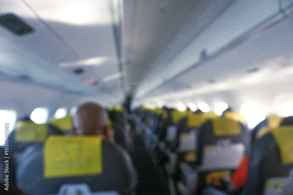 Interior Of Airplane With Passengers On Seats In Blurry Image. Interior Of Airplane With Passengers On Seats In Blurry Image.