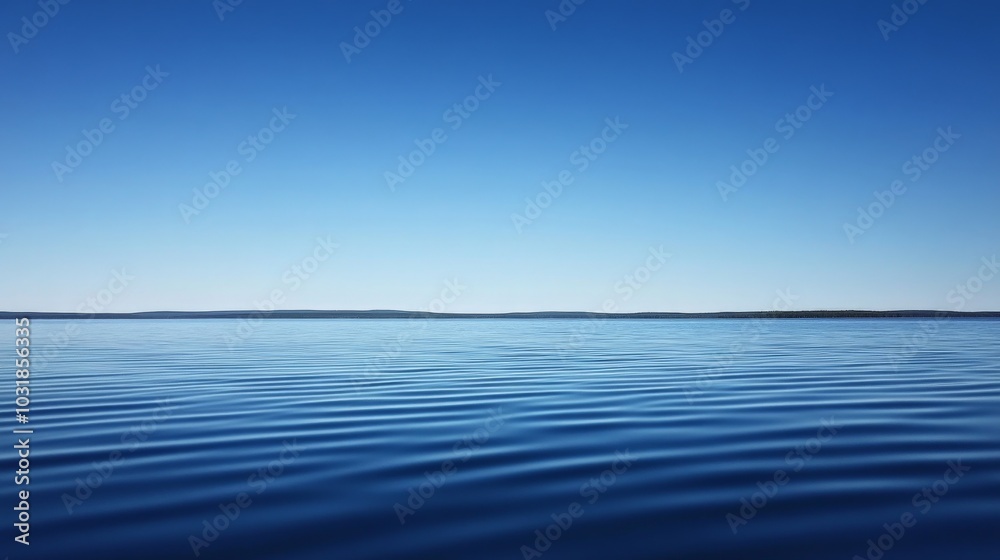 Obraz premium Serene Lake Landscape with Clear Blue Sky and Calm Water
