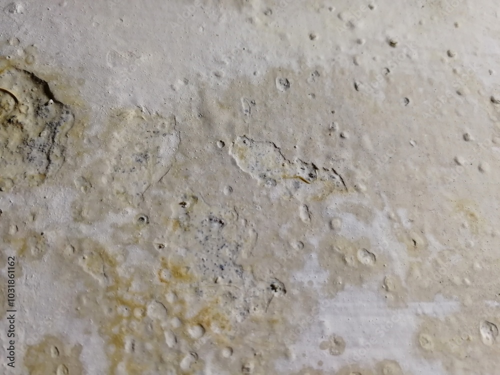 Damaged peeling paint on the interior wall due to water leakage. Cracked color paint background for reference, example, sample etc. Usually this condition happens when wall is wet or old Damaged peeling paint on the interior wall due to water leakage. Cracked color paint background for reference, example, sample etc. Usually this condition happens when wall is wet or old