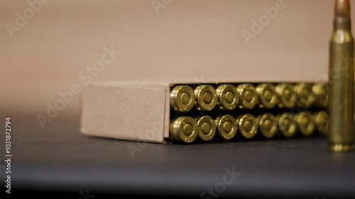 Extreme close up and slow motion of fresh boxed ammo. photo