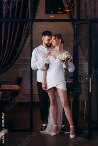 Wedding couple hugging in the interior. Full lenth portrait photo