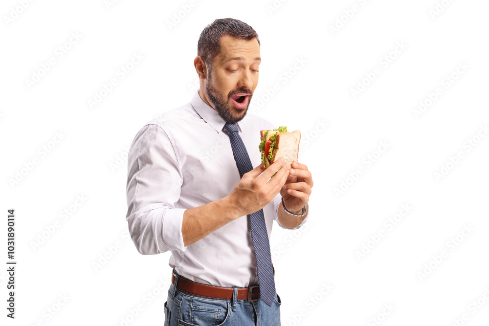 Happy businessman eating a cheese sandwich with lettuce and tomato Happy businessman eating a cheese sandwich with lettuce and tomato