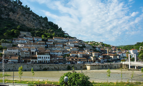 Traditional Ottoman houses in the historic Mangalem quarter of Berat, Albania. UNESCO World Heritage Site listed, known as City of a Thousand Windows. Kalaja Hill in the background. White Bridge right