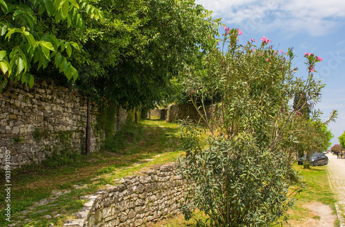 A narrow grassy lane in the historic residential quarter of the castle district, Kalaja, of Berat in southern Albania. UNESCO World Heritage Site listed
