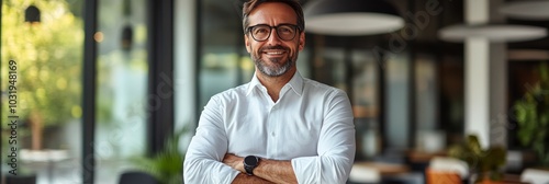 Confident professional in a modern office smiling warmly while standing with ...
