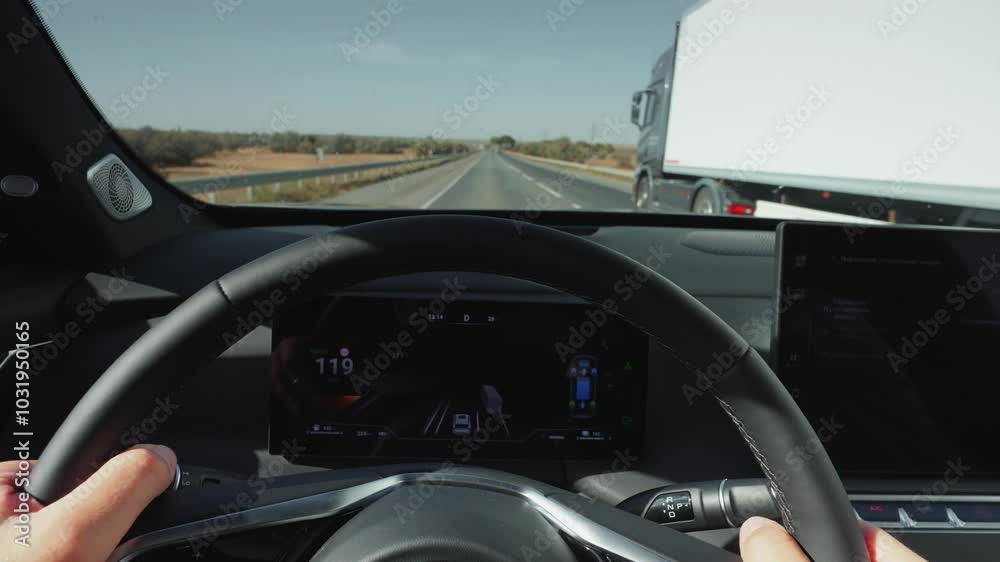 The driver overtakes other cars. View from behind the wheel of a car. Hybrid car, clean energy The driver overtakes other cars. View from behind the wheel of a car. Hybrid car, clean energy