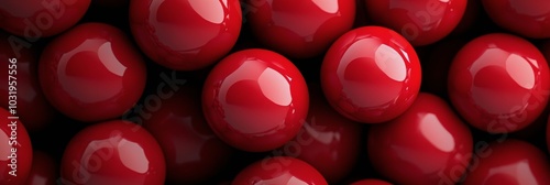 Close up view of shiny red balls arranged neatly on a flat surface during day...
