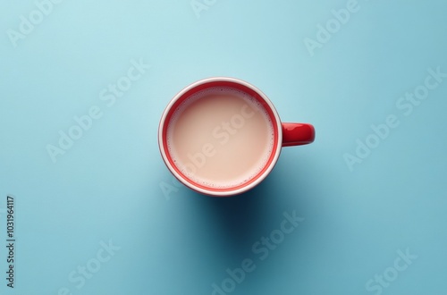 A steaming cup of coffee in a bright red mug on a blue surface showing mornin...