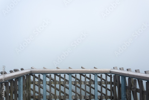 Obraz na płótnie Balustrade on the top of an observation tower in the mountains, thick morning fog in the forest. w salonie