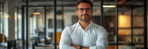 Confident professional in a modern office smiling warmly while standing with ...