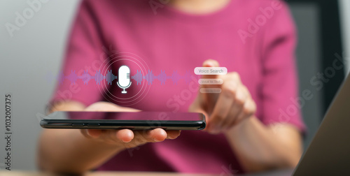 Hand holding smartphone with using voice search application.