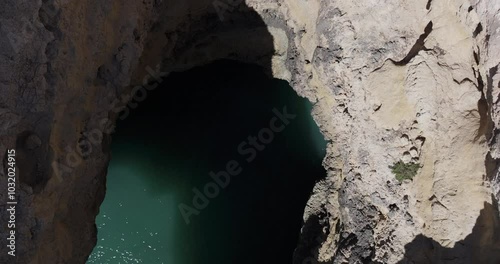 Aerial drone view from drone descending in sea cave on the Atlantic Ocean coastline in Benagil, Algarve, Portugal, Europe. Nature in the Mediterranean. Shot in 5K ProRes 422HQ, exported in ProRes