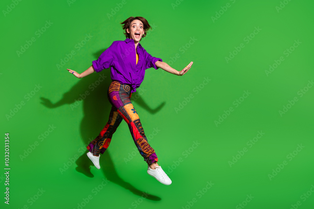 Full body length photo of crazy young hipster girl wearing old school style clothing jumping run hurry up isolated on green color background