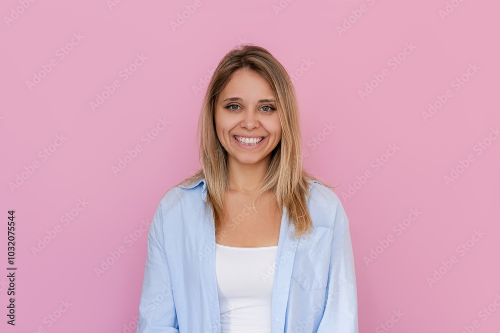 Portrait of sad upset young caucasian blonde woman in a blue shirt isolated on a pink background. Negative emotions, bad mood Portrait of sad upset young caucasian blonde woman in a blue shirt isolated on a pink background. Negative emotions, bad mood
