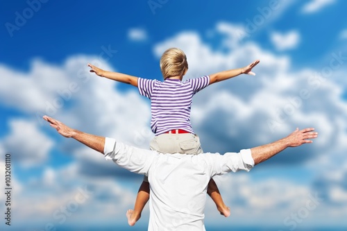 Father holding son playing together outdoor