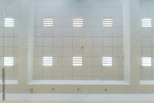 cassette stretched or suspended ceiling with square halogen spots lamps and drywall construction in empty room in house or office. Looking up view photo