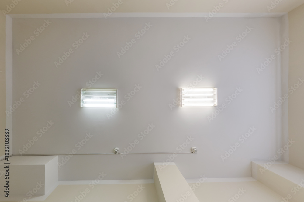 cassette stretched or suspended ceiling with square halogen spots lamps and drywall construction in empty room in house or office. Looking up view cassette stretched or suspended ceiling with square halogen spots lamps and drywall construction in empty room in house or office. Looking up view