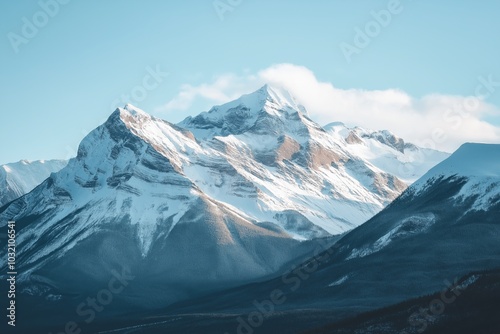 Snowy mountain peaks rise majestically under a clear blue sky, capturing the essence of nature's grandeur and tranquility.