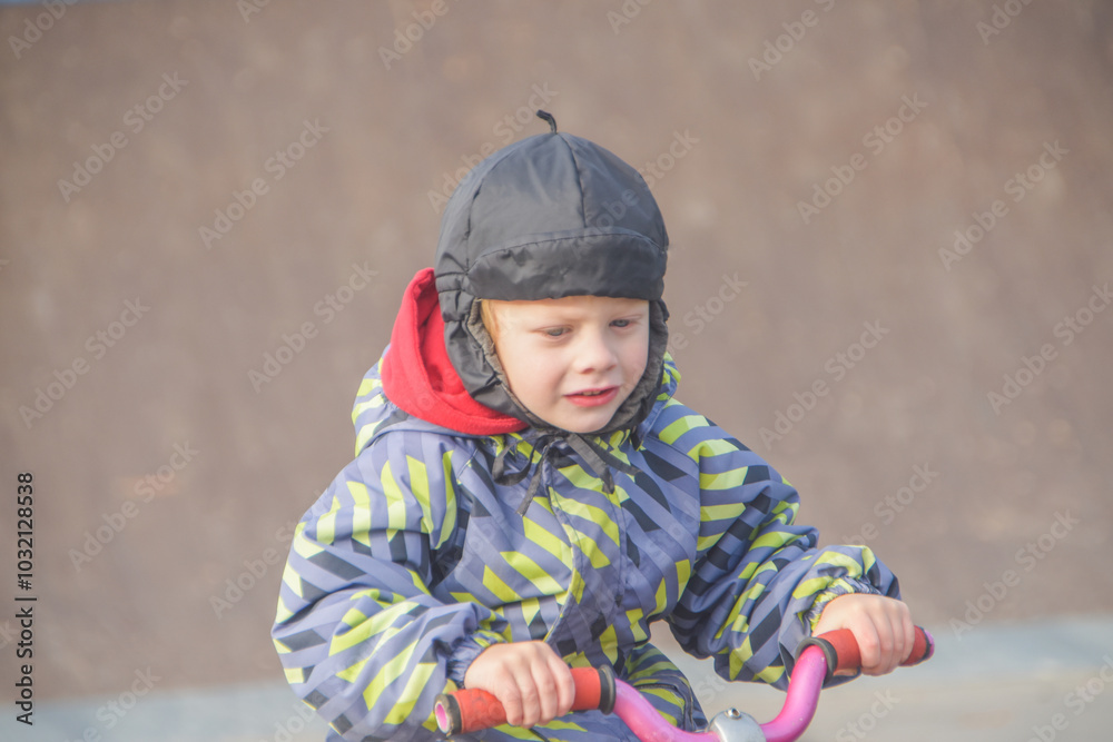 a child, a boy riding a running bike, a bicycle on a sports field, a photo without filters a child, a boy riding a running bike, a bicycle on a sports field, a photo without filters