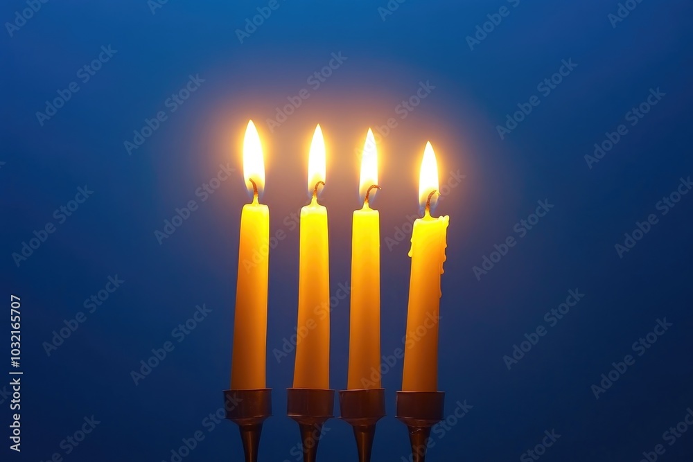 A group of four candles sitting on a table, perfect for interior design or event decoration A group of four candles sitting on a table, perfect for interior design or event decoration