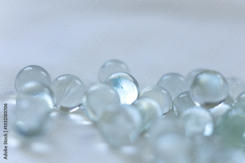 clear Glass marbles on a white background, close-up, selective focus clear Glass marbles on a white background, close-up, selective focus