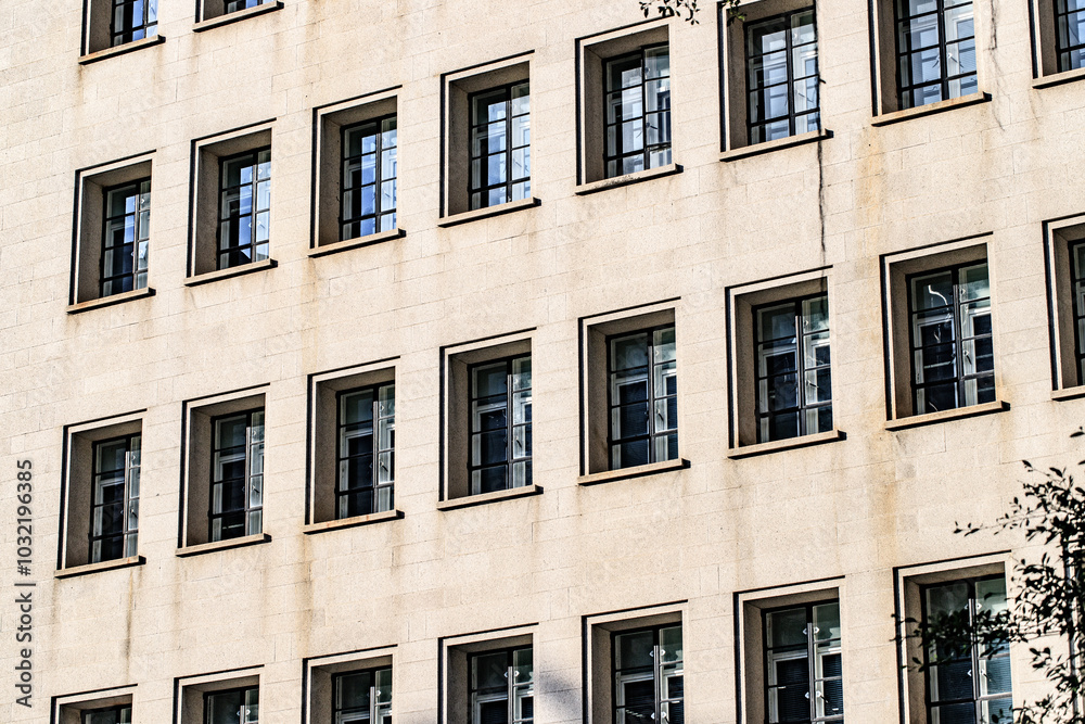 Symmetrical Windows on a Modern Beige Building Facade Symmetrical Windows on a Modern Beige Building Facade