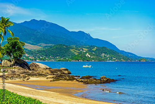 Beach in the urban area of ​​Ilhabela island surrounded by mountains and forests